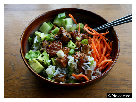 Spicy pork rice bowl with fresh vegetables and sesame seeds